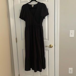 Black wrap dress with flutter sleeves.